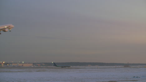 Airplane-taking-off-Airport-view-in-winter-evening