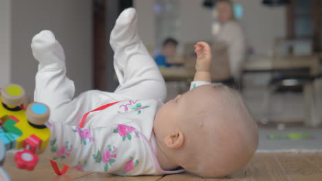 Eight-months-baby-girl-playing-with-toy-at-home