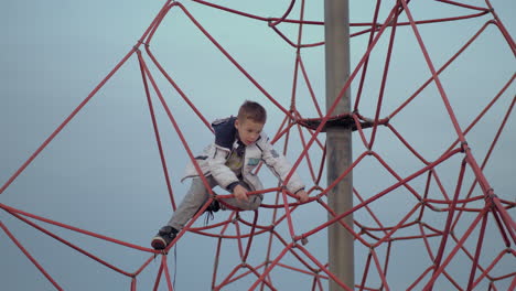 A-boy-on-a-red-climbing-web