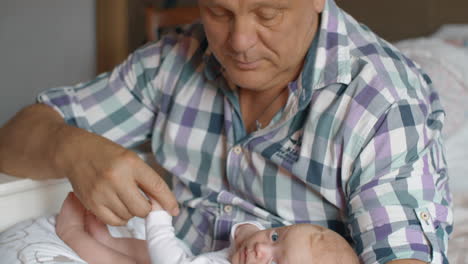 Grandfather-holding-newborn-baby-girl