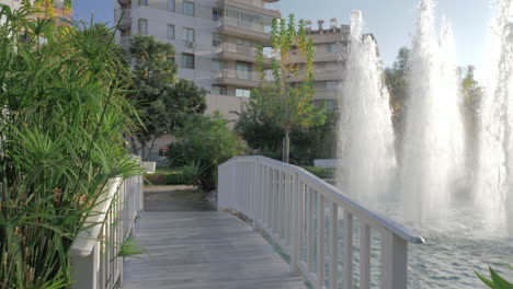 A-steadicam-shot-of-a-beautiful-pond-with-fountains