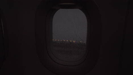 An-evening-rainy-view-from-an-airplane-porthole