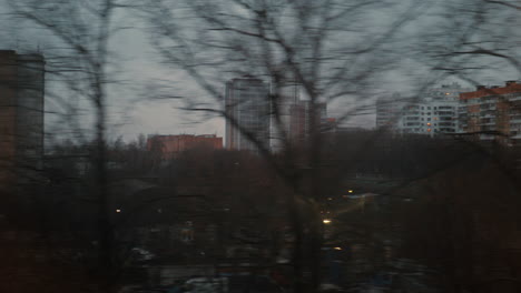 Looking-at-evening-city-from-the-window-of-moving-train-Russia
