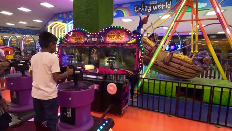 POV-SHOT-A-kid-stands-up-and-plays-a-game-with-friends-in-a-crazy-world-inside-the-mall