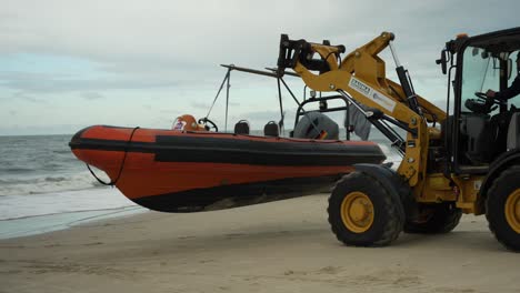 Carretilla-Elevadora-Que-Transporta-El-Barco-En-La-Playa-De-Arena,-Tripulación-De-Eventos-De-Deportes-Acuáticos