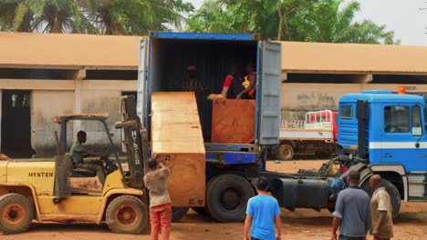 black-labor-in-sawmill-factory-in-africa-loading-a-truck-with-electric-forklift-in-a-sawmill-factory