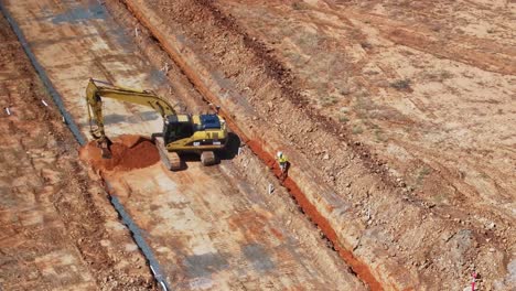 Yarrawonga,-Victoria,-Australia---22-November-2023:-Track-loader-scoops-up-a-bucket-of-soil-and-then-pulls-back-the-pile-of-soil-to-make-it-easier-to-scoop-up