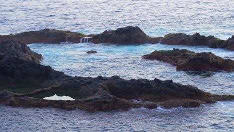 Rock-formations-at-the-surface-of-the-water-in-the-middle-of-the-sea-of-Canary-Island,-Tenerife