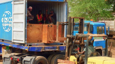 loading-a-trunk-tree-cut-into-a-truck-for-oversea-shipping-in-africa-deforestation-concept