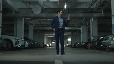 Man-approaches-a-his-luxury-car-in-a-parking-garage-realizes-that-he-forgot-the-keys-and-leaves-annoyed