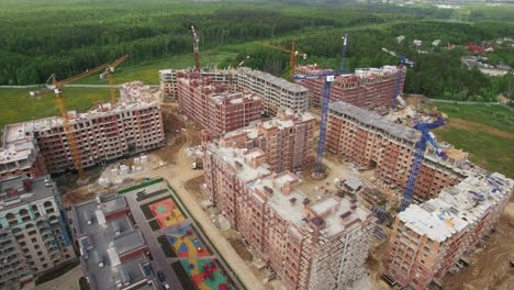 An-aerial-view-of-a-construction-site-near-the-green-forest