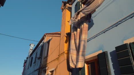 Ropa-De-Cama-Ondeando-Al-Viento-En-Una-De-Las-Fachadas-De-Burano-Italiano