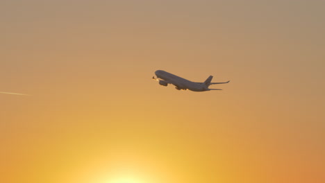 Plane-of-China-Eastern-Airlines-flying-against-sky-at-sunset