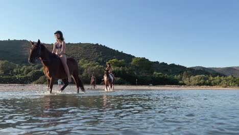 People-ride-horses-in-seawater-in-summer-season