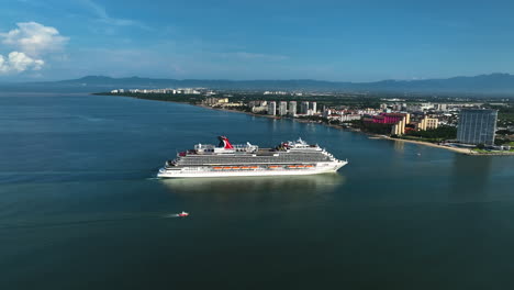 Large-luxury-cruise-liner-entering-the-coastline-of-sunny-Mexico---Aerial-view