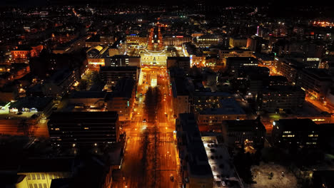 Aerial-ascending-shot-overlooking-the-illuminated-downtown-of-Vaasa,-Finland