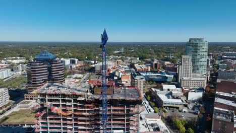 Construction-crane-towering-over-a-building-site-in-a-cityscape-in-Durham,-North-Carolina