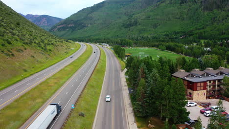 Drone-shot-rising-over-a-truck-on-interstate-70,-in-cloudy-Vail,-Colorado,-USA