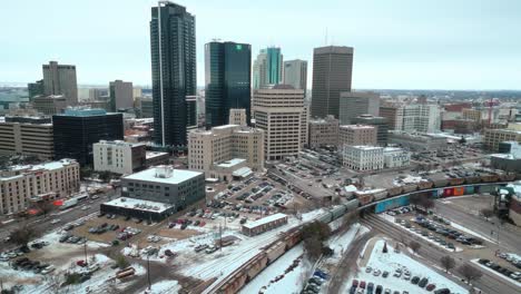 A-4K-Establishing-Cinematic-Drone-Shot-of-Downtown-Treaty-One-Land-Skyscrapers-Buildings-Arena-Shaw-Park-Baseball-Diamond-Urban-Landscape-Winter-in-Capital-City-Winnipeg-Manitoba-Canada