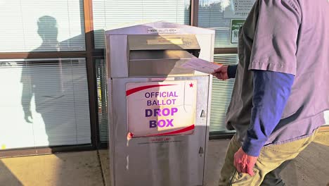 Man-and-Woman-Vote-in-Election-by-Mail-at-Official-Ballot-Drop-Box-Sign-for-American-Democratic-Government-Presidential-Race-by-Casting-Ballot-in-Slot,-Mail-in-Letter