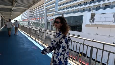 Tourists-walk-on-the-deck-of-a-ship-that-will-cruise-around-the-waters-in-Barcelona,-Spain