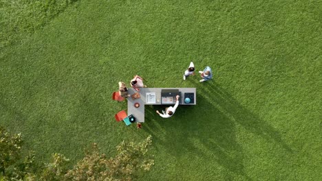 Top-Down-Shot-Of-Group-Of-Friends-Cooking-Outdoor-At-Sunny-Day