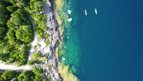 Time-to-relax-and-kayaking-in-Georgian-Bay-with-turquoise-lake-and-rocky-coast-in-Ontario,-Canada