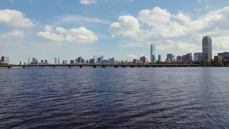 Aerial-fly-over-Charles-river-toward-Harvard-bridge,-Boston-city-skyline