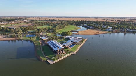 Yarrawonga,-Victoria,-Australia---22-November-2023:-Aerial-approaching-the-Sebel-Hotel-with-golf-course-new-homes-and-farm-fields-in-the-distance