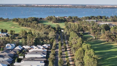 Yarrawonga,-Victoria,-Australia---22-November-2023:-Aerial-of-Silverwoods-Boulevard-and-heading-towards-the-Sebel-Hotel-and-Lake-Mulwala