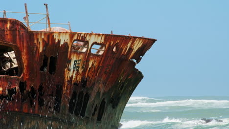 Rusty-weather-beaten-Meisho-Maru-No-38-shipwreck-on-Agulhas-coastline,-telephoto