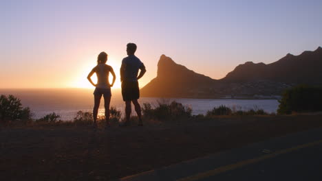 Man-and-woman-admiring-a-coastal-view-after-jogging
