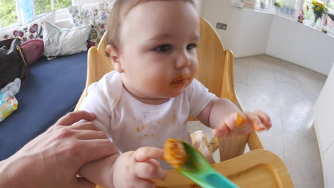 Point-Of-View-Shot-Of-Baby-Being-Fed-In-High-Chair