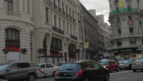 Gran-Via-street-with-road-traffic-and-Edificio-Metropolis-Madrid-Spain