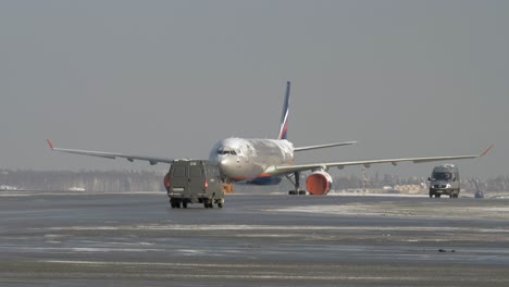 Tug-towing-ice-covered-aircraft-of-Aeroflot-Russia