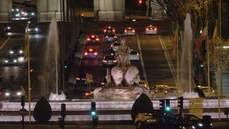 Fountain-of-Cybele-and-transport-traffic-on-Alcala-street-in-night-Madrid-Spain