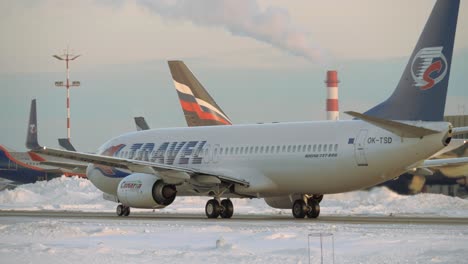 Aircraft-of-Travel-Service-taxiing-on-tarmac-at-Moscow-airport-winter-view