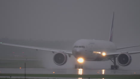 Airplane-of-Aeroflot-taxiing-on-wet-tarmac-in-the-rain