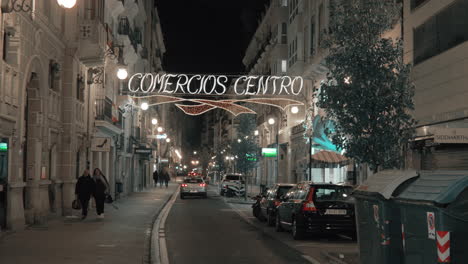 Night-view-of-Carre-de-Ribera-with-car-traffic-and-closed-shops-Valencia-Spain