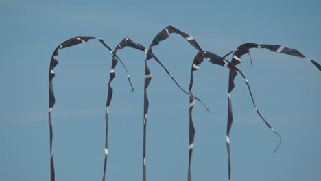 Swaying-fabric-strips-on-sky-background