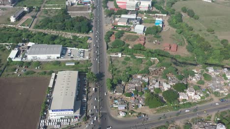 The-drone-camera-is-moving-forward-showing-large-fields-showing-large-fields-and-tenement-houses