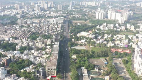 Rajkot-city-aerial-view-Drone-is-passing-through-the-center-of-Rajkot-city,-surrounded-by-temples-and-residential-buildings