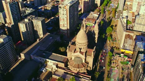 Aerial-Panoramic-Above-Los-Sacramentinos-Church-Cityscape-Daylight-Urban-Streets-of-Santiago-de-Chile,-Drone-Shot