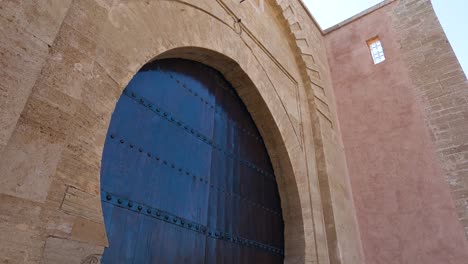Tilt-down-along-Bab-Laalou-large-wooden-keystone-gate-in-Rabat-Morocco