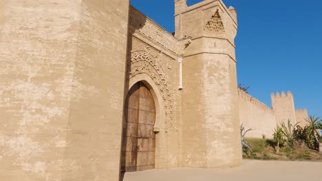 Atemberaubende-Türme-Der-Zitadelle-An-Der-Seite-Des-Hölzernen-Schlüssellochtors-In-Chellah,-Rabat,-Marokko