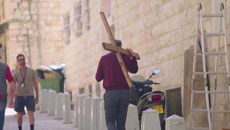 Man-Carrying-Wooden-Cross-To-The-Western-Wall-In-Jerusalem,-Israel