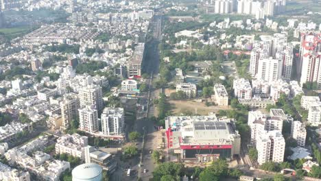 Rajkot-city-aerial-view-A-lot-of-vehicle-traffic-and-big-buses-are-going-on-the-road-of-Crystal-Mall
