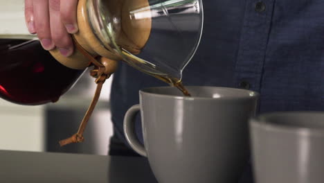 Pouring-Fresh-Black-Coffee-from-a-Carafe-into-a-Coffee-Mug-at-Home,-Slow-Motion