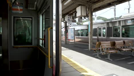 Looking-Out-Open-Train-Doors-As-Local-Train-Seen-Arriving-At-Opposite-Platform-At-Mitaki-Train-Station-In-Hiroshima