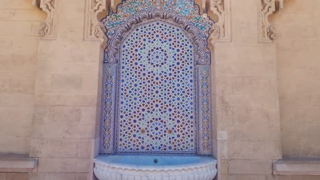 Tilt-down-reveals-intricate-fountain-at-Al-Hassan-Mosque-in-Rabbat-Morocco